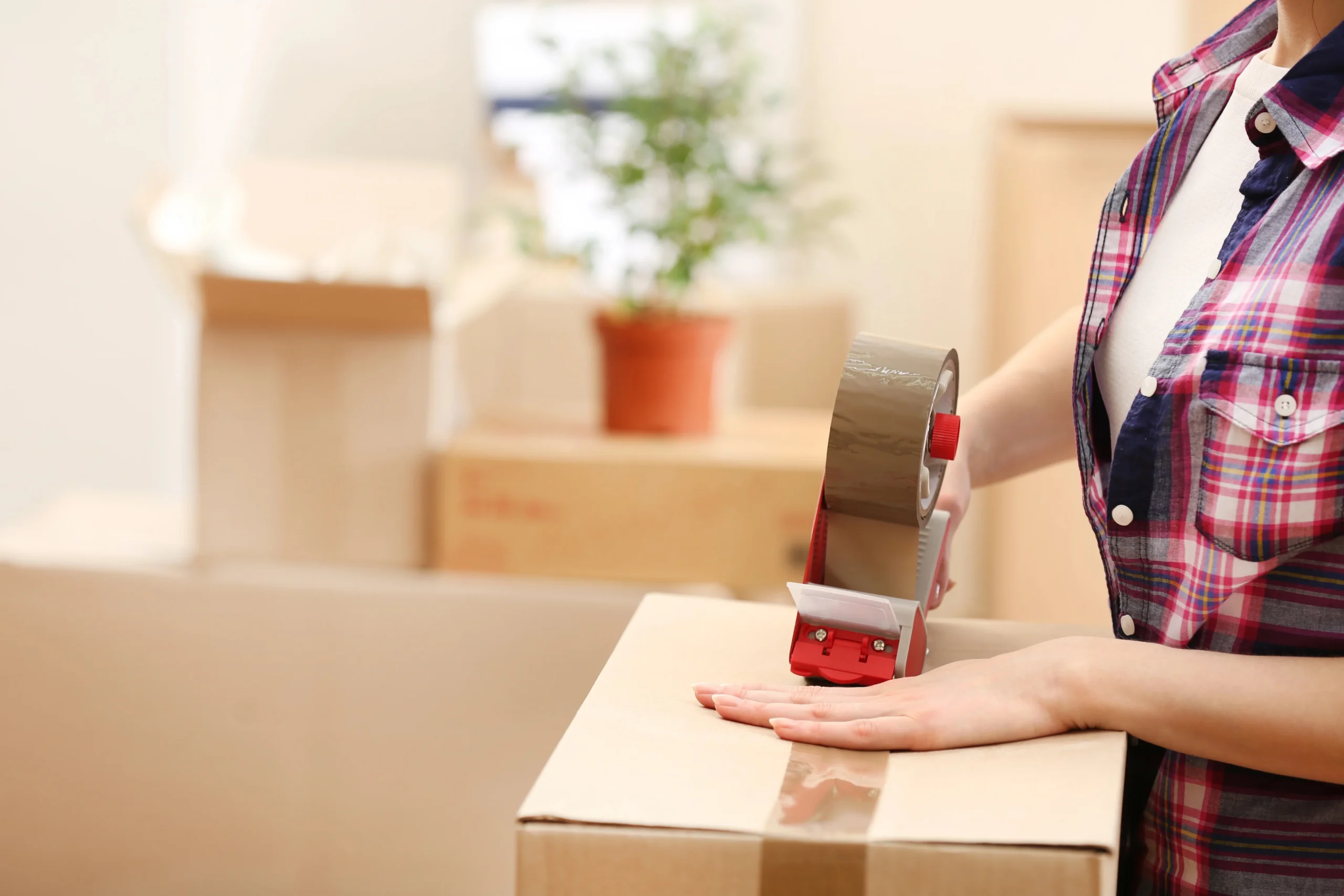 Staff Member Taping Boxes To Deliver Trusted Packing & Unpacking Services
